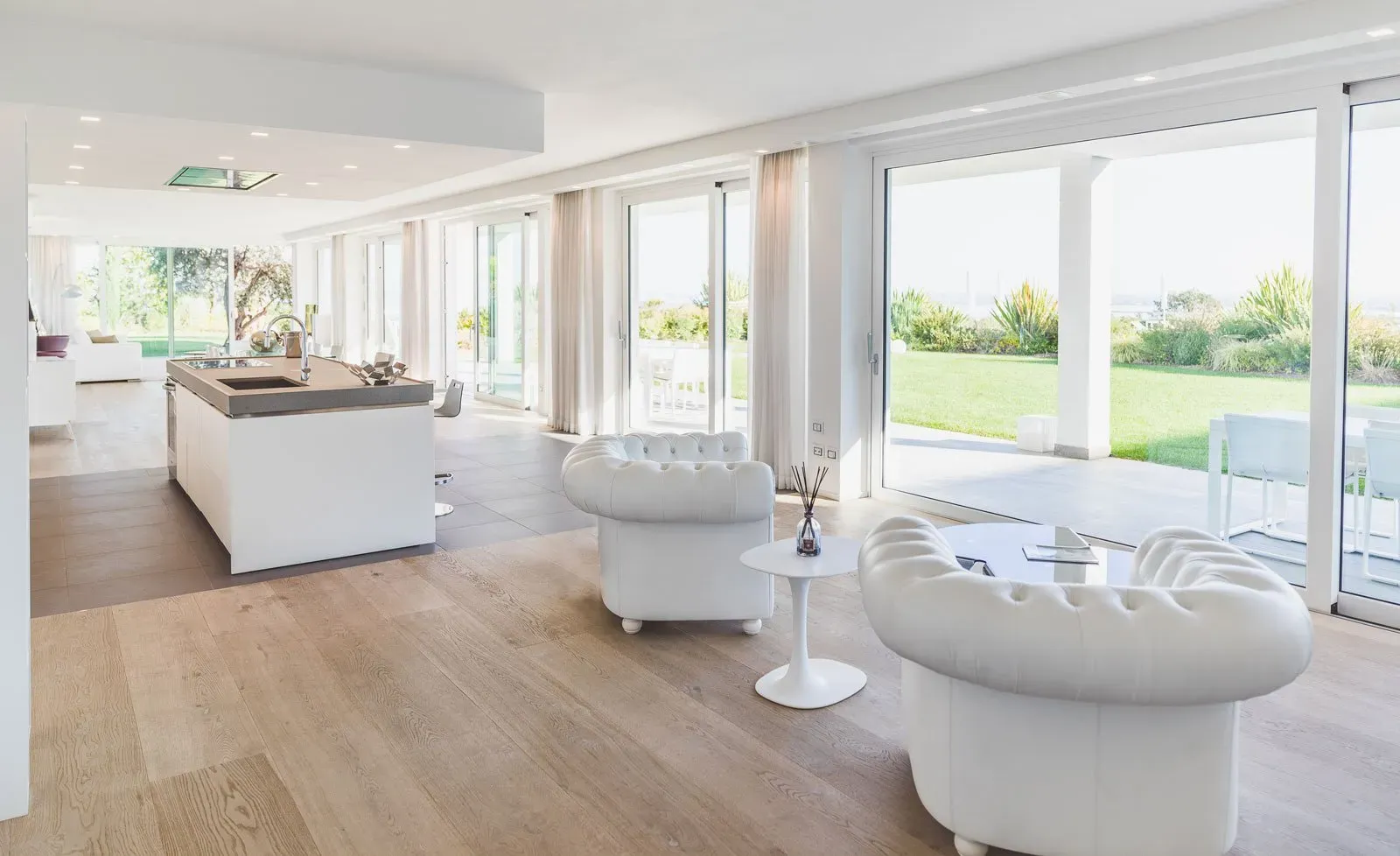 open and spacious living room featuring large windows and patio doors.